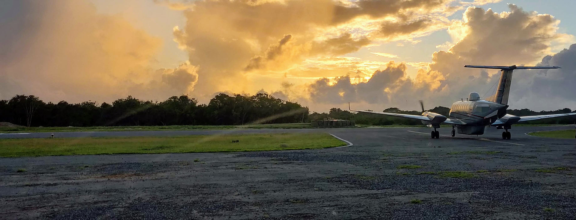 Aircraft on runway at sunset